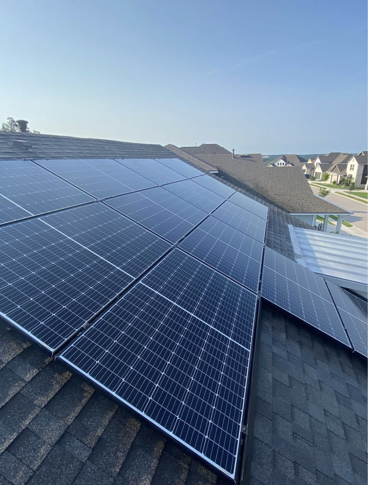 Rooftop solar panels cleaned to a spotless shine under a clear sky